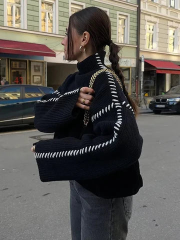 Chic women's oversized black sweater. Elegant pullover top, great for layering in fall & winter fashion.