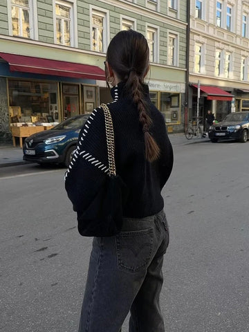 Black oversized long sleeve pullover sweater for women. Cozy and elegant for everyday winter fashion.