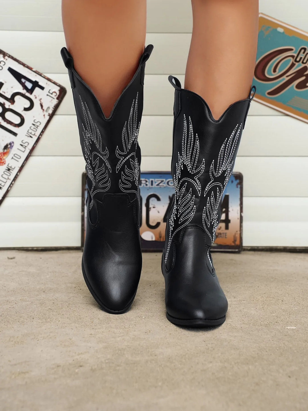 Low heel women's fashion boots, western style with elegant stitching and a pointed toe.