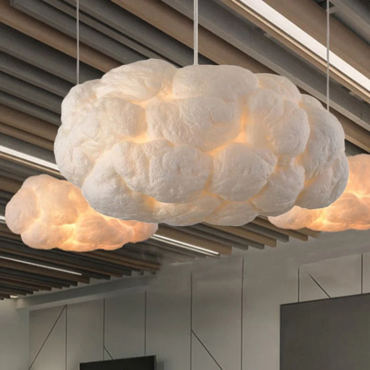 Elegant white cloud LED pendant light, PVC/Cotton, provides modern ambient indoor lighting.