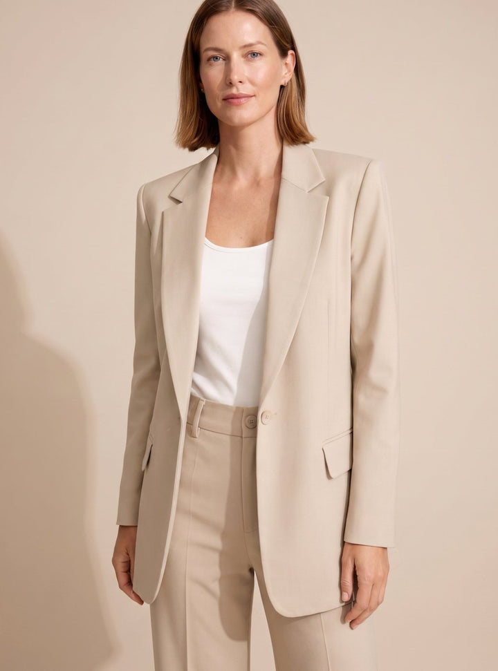 Women's elegant two-piece suit: chic blazer & sophisticated flared trousers for professional office wear.