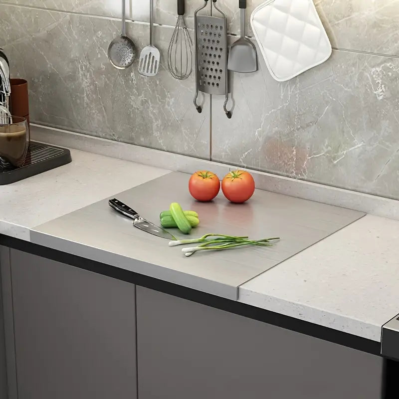 Sleek stainless steel cutting board, perfect for kitchen food prep. Double-sided and easy to clean.