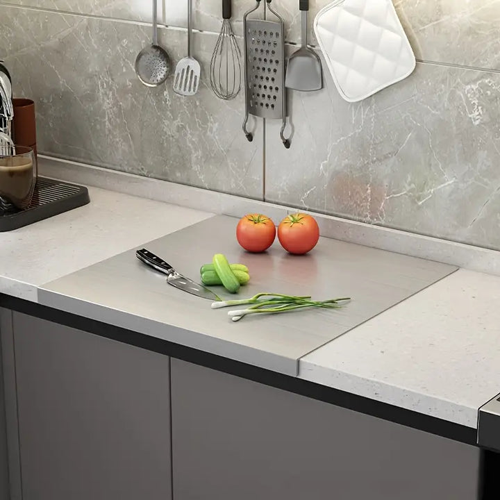 Sleek stainless steel cutting board, perfect for kitchen food prep. Double-sided and easy to clean.