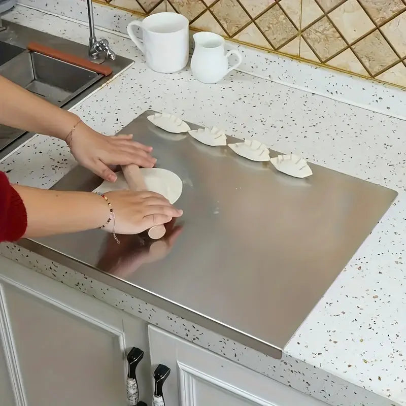 Close-up of a non-slip stainless steel chopping board surface, ideal for kitchen food prep.