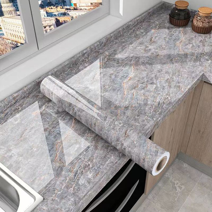 Peel and stick marble kitchen wrap protects countertops. Waterproof, oil-resistant surface film for easy home improvement.