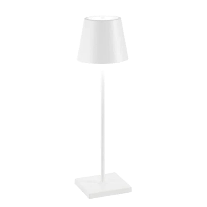 Contemporary LED table lamp, wireless and portable, casting a warm glow on a wooden nightstand.