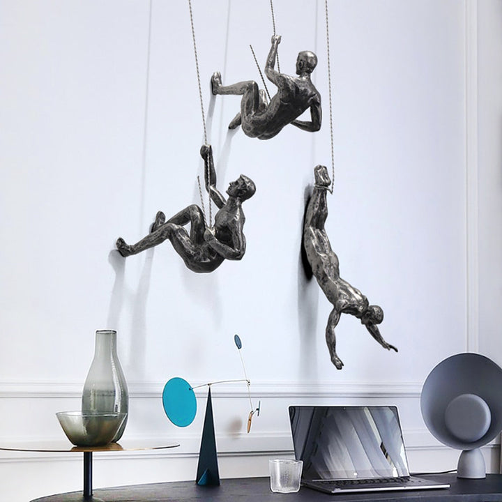 Dynamic climber wall art representing strength, a modern sculpture for inspirational home and office decor.