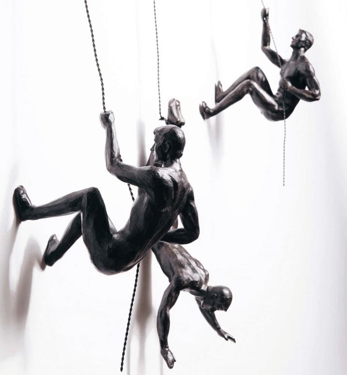 Sleek metallic climber wall art sculpture, bringing modern and inspirational decor to any room.