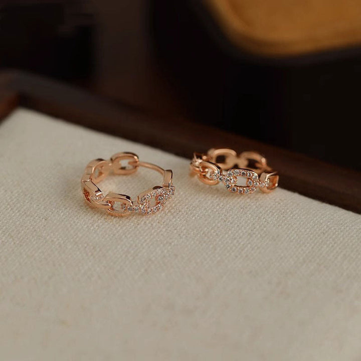Dainty diamond stud earrings for women, available in shimmering rose gold.