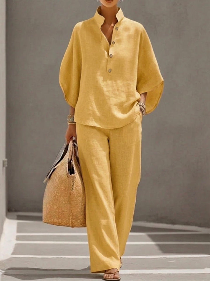 Stylish women's two-piece set with a loose batwing top and wide-leg trousers, great for resort & vacation.