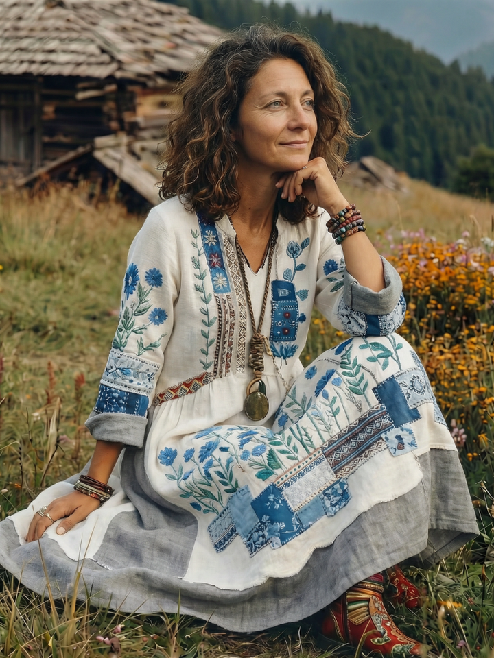 Stylish women's midi dress with long sleeves, elegant embroidery, and comfortable panel design. V-neck for chic look.