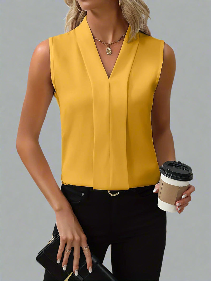 Chic Quinn pleated sleeveless V-neck blouse, an elegant smart casual top for women, ideal for office or summer.