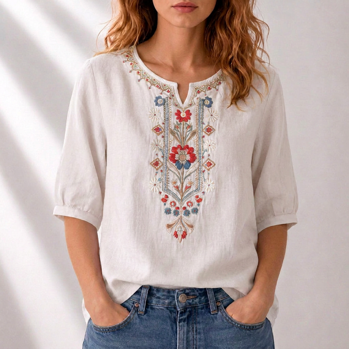 Stylish women's embroidered top with vibrant floral patterns. Comfortable relaxed fit for spring/summer.