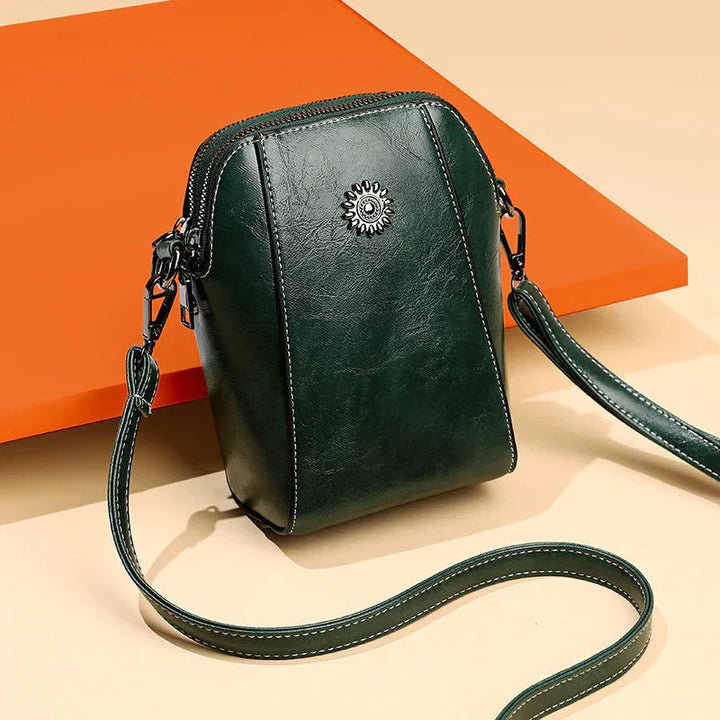 Stylish women's black leather shoulder bag, versatile everyday handbag with an adjustable strap.