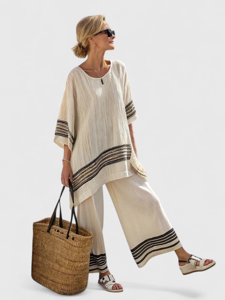 Women's summer two-piece set: oversized, asymmetrical top, wide-leg pants. A comfortable & stylish vacation ensemble.