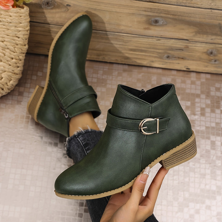 Women's black Chelsea ankle boots with modern buckle detail, side zip, and comfortable low block heel.