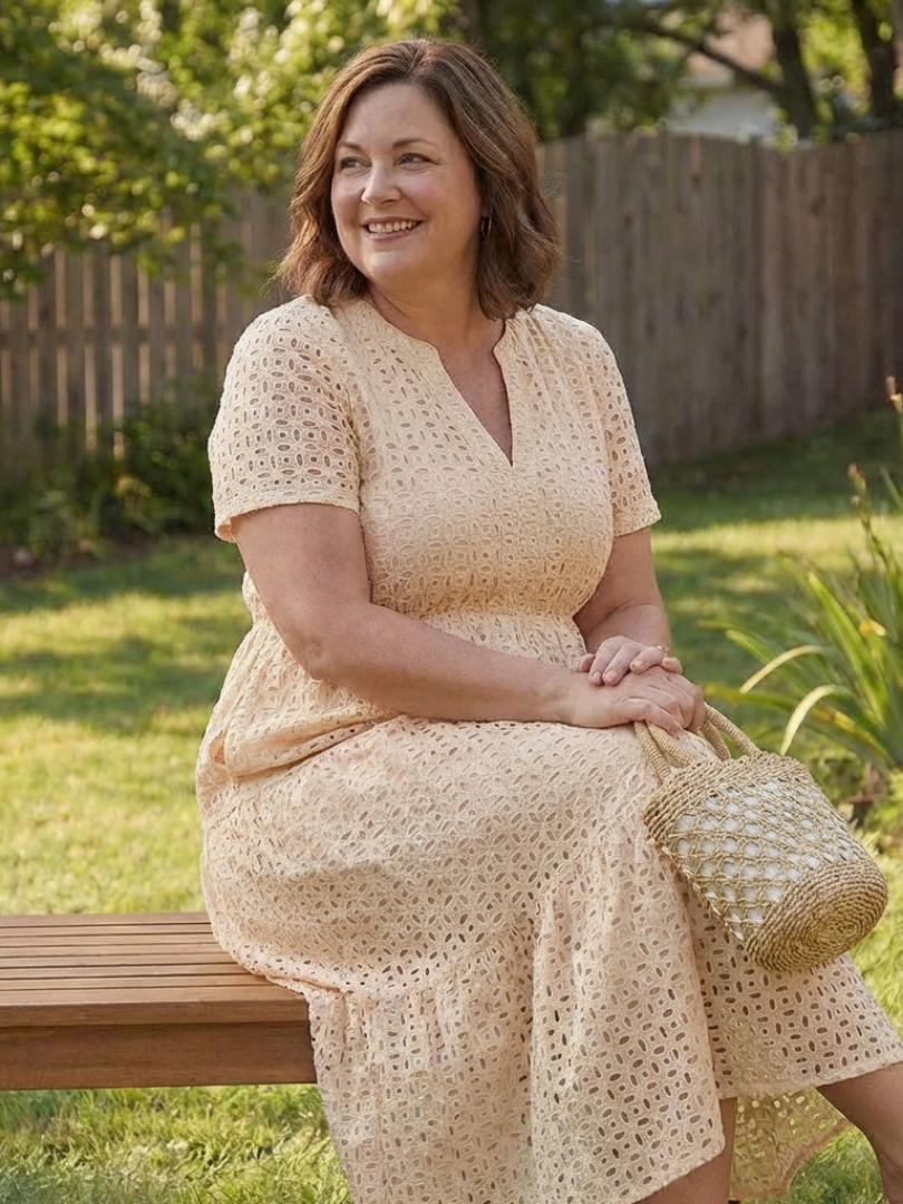 White eyelet midi dress with short sleeves and a charming tiered skirt, an essential women's spring-summer dress.