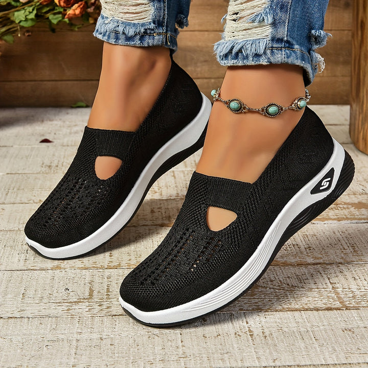 Close-up of women's orthopedic slip-on shoe showing arch support and cushioned sole for comfort.