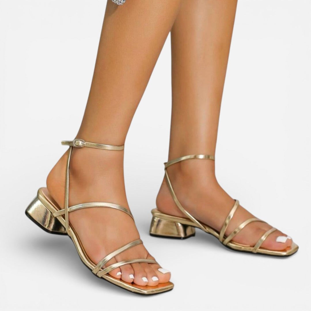 Women's gold metallic strappy block heel sandals. Elegant occasion wear for parties.