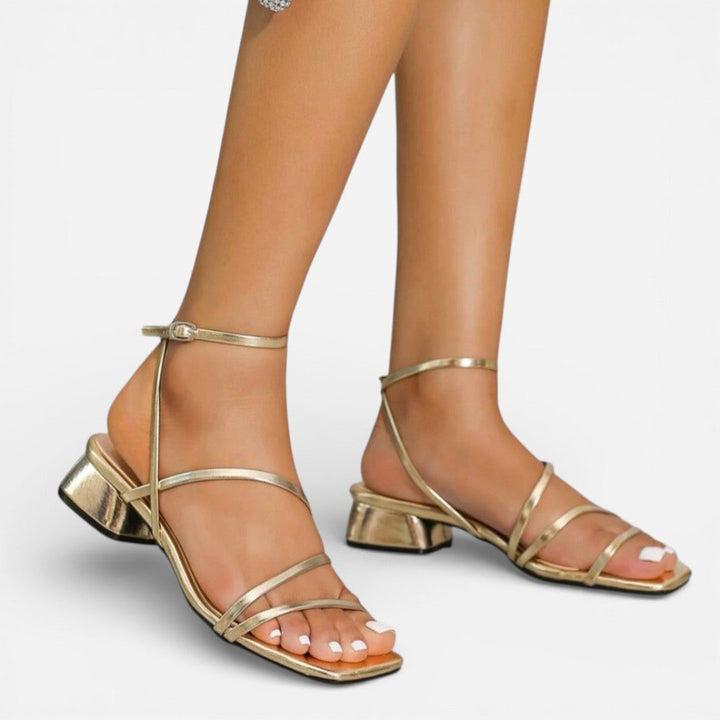 Women's gold metallic strappy block heel sandals. Elegant occasion wear for parties.