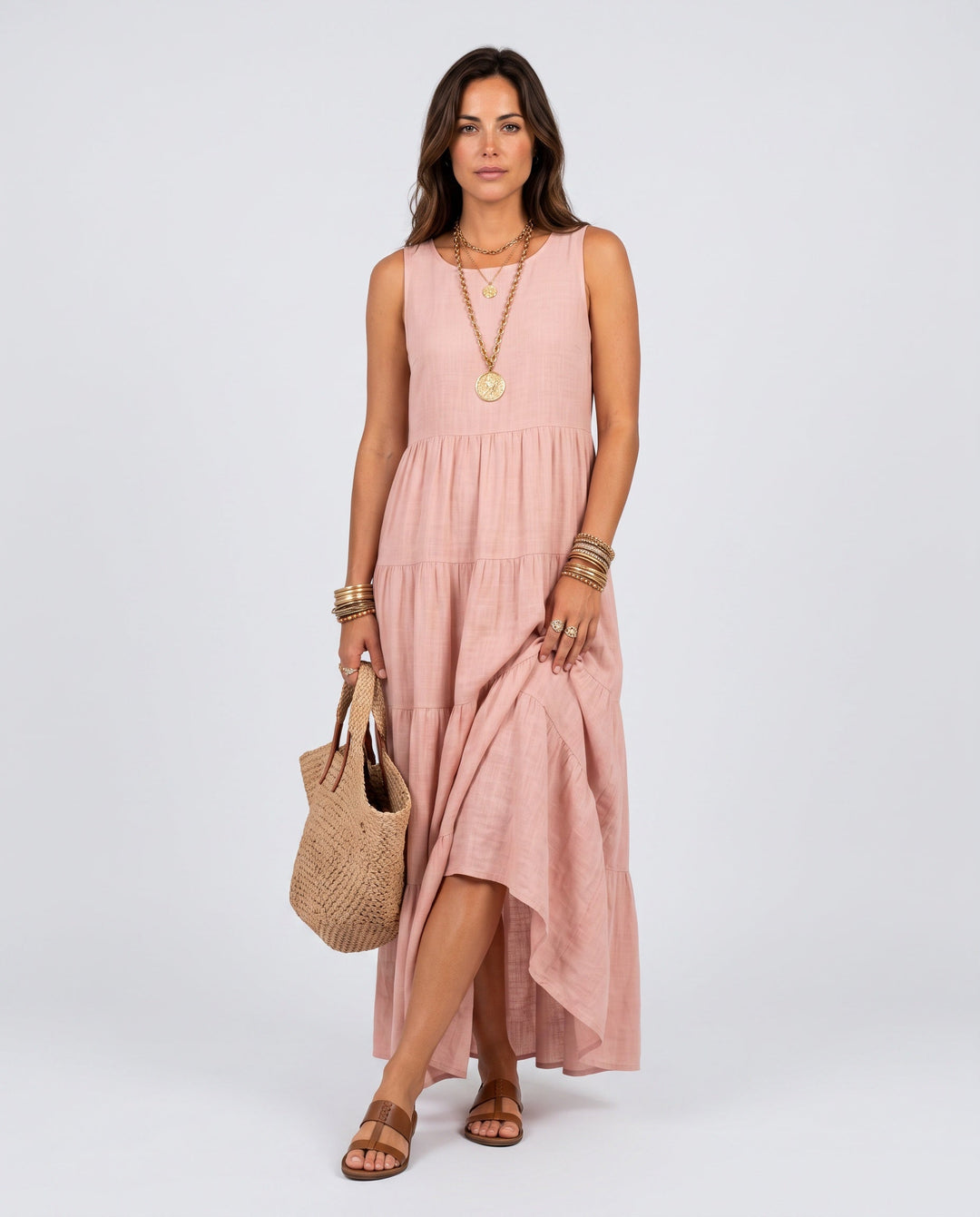 Elegant pink tiered high-low maxi dress for women, sleeveless and flowy, perfect for summer parties or vacation.