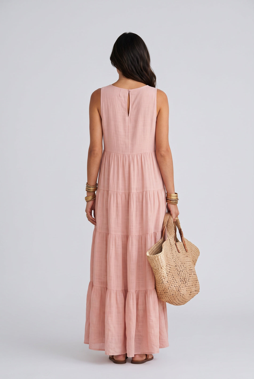 Women's sleeveless pink tiered high-low maxi dress, a stylish and flowy summer dress for casual or party wear.