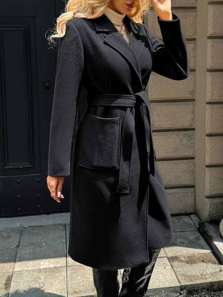 Detail of tailored sleeves on a women's elegant trench coat. Classic fashion and sophisticated style.