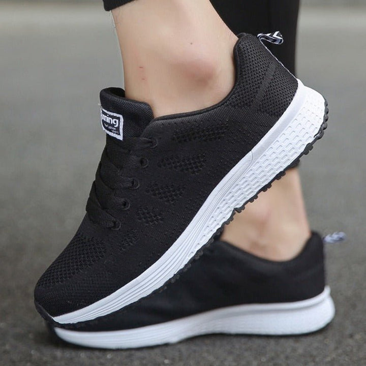 Comfortable women's orthopedic sneaker, side view showcasing supportive design & durable sole for walking.