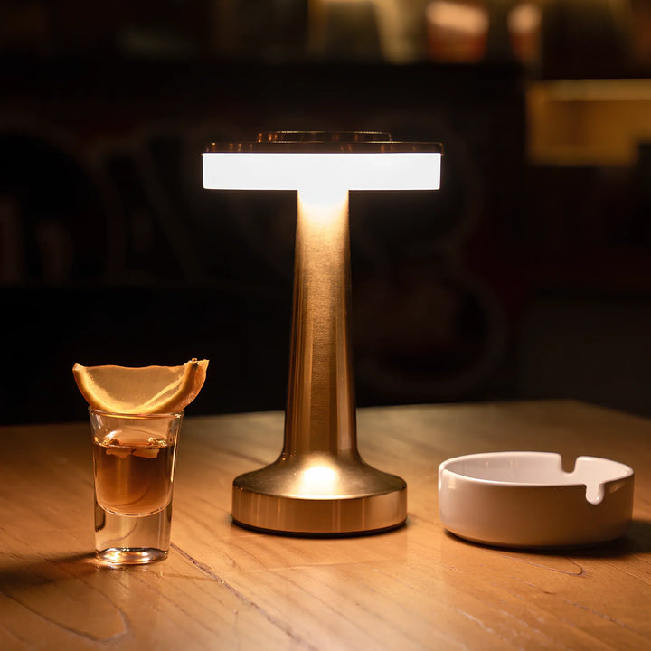 Cordless LED retro lamp for bars. Rechargeable, metallic, providing modern vintage accent light.