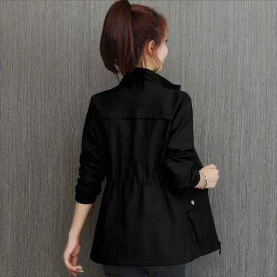 Casual women's waterproof jacket with cinched waist, perfect travel outerwear for any weather.