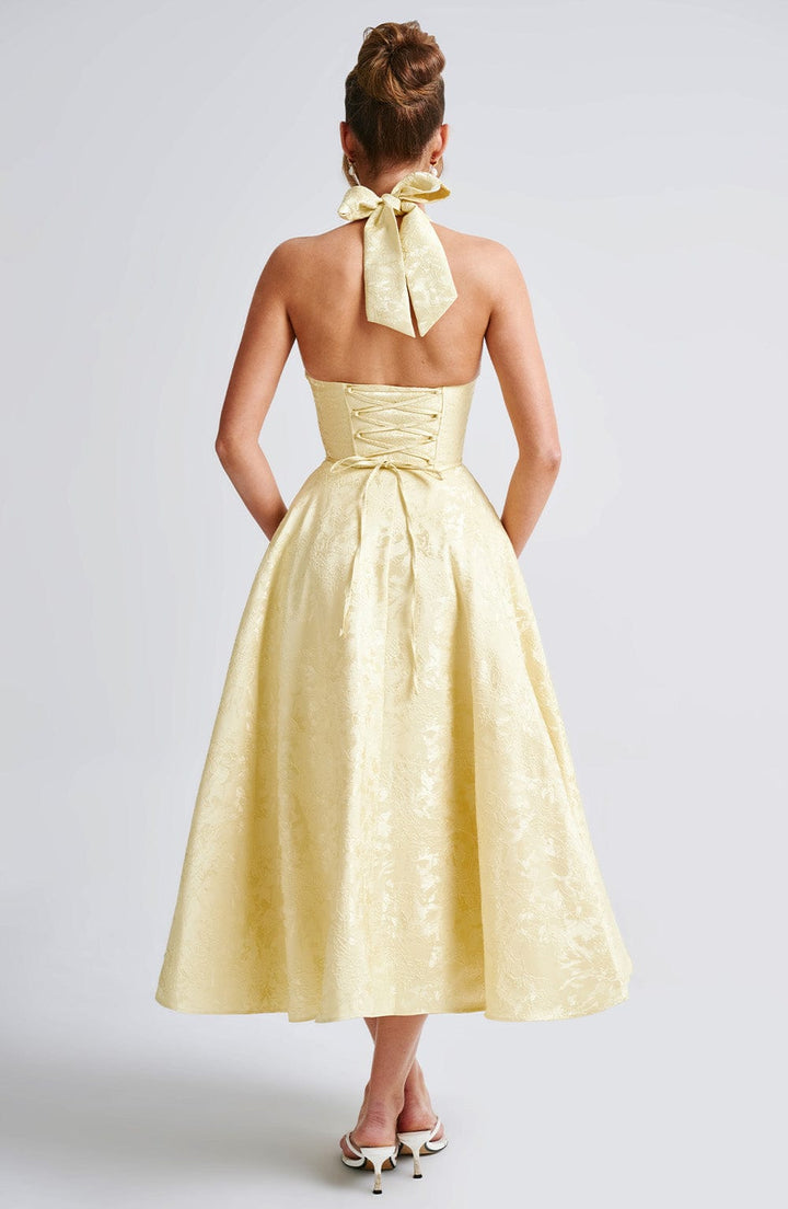 Women's elegant halter midi dress, a sophisticated option for wedding guests & parties.