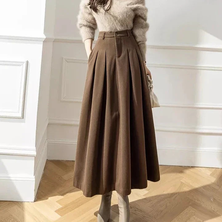 Women's elegant black pleated A-line midi skirt, perfect for autumn and winter fashion.