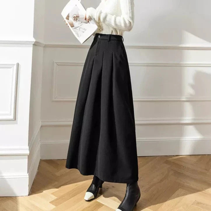 Women's casual black pleated midi skirt, featuring an A-line cut and elegant flow.