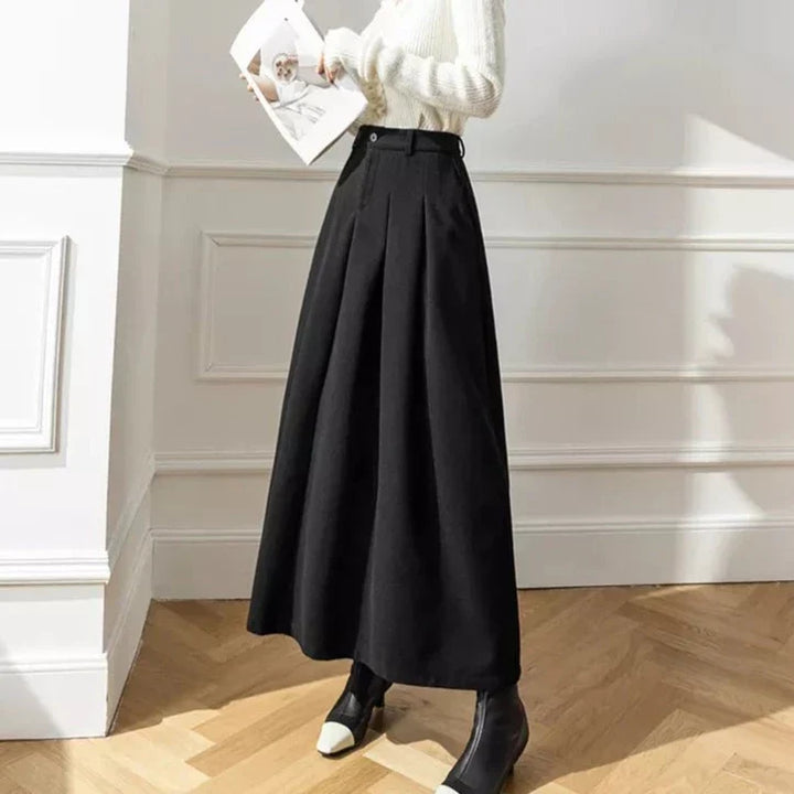 Women's casual black pleated midi skirt, featuring an A-line cut and elegant flow.