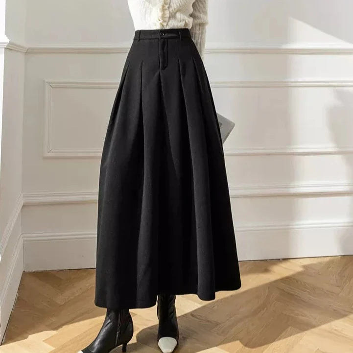 High-waist brown A-line midi skirt with subtle pleats and convenient pockets for women.