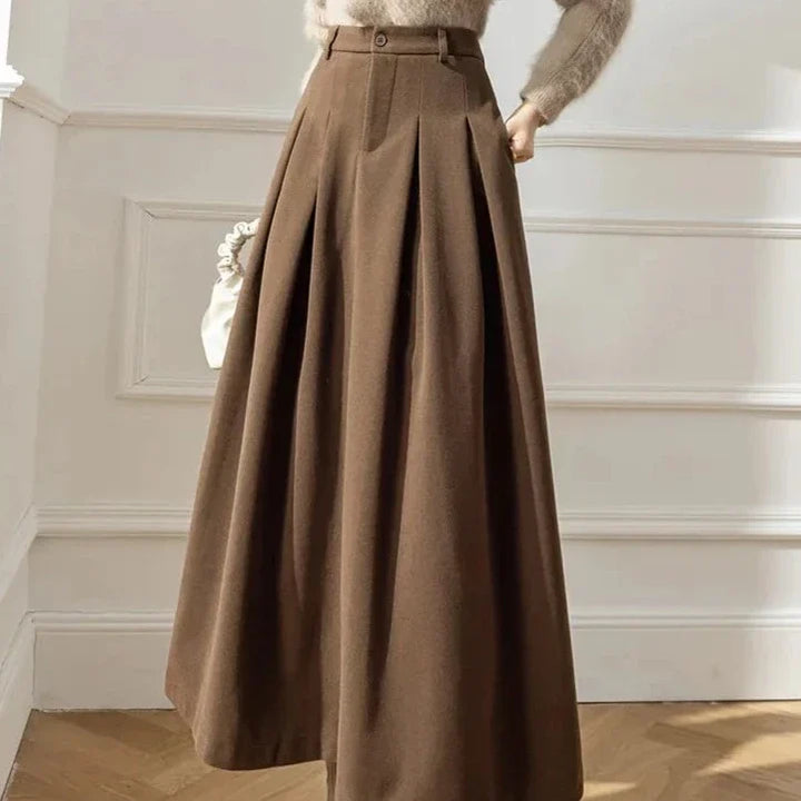 Flowy black pleated midi skirt for women, an elegant and casual autumn/winter fashion piece.