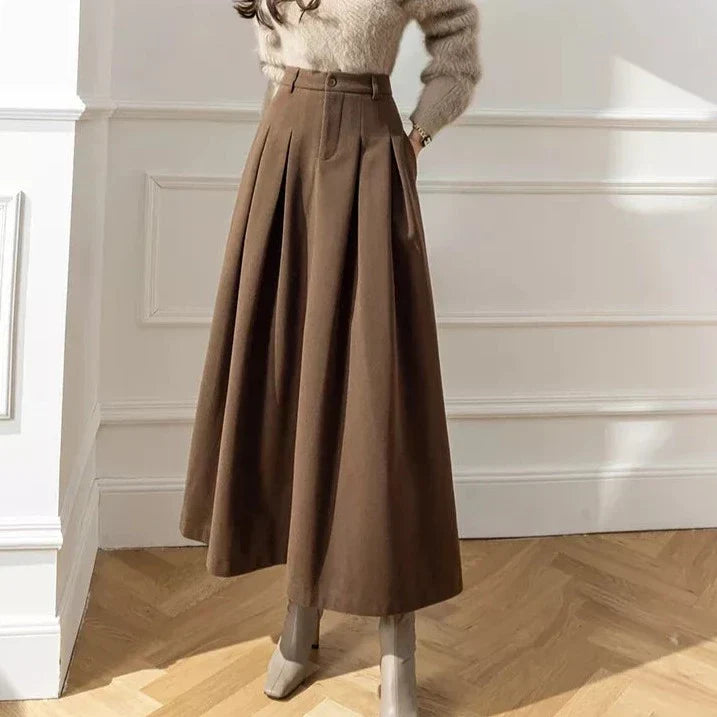 Women's comfortable brown A-line midi skirt with stylish pleats and pockets.