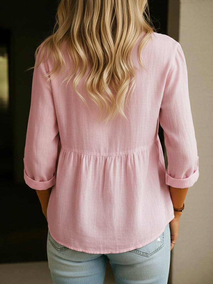 Casual yet elegant button-down peplum tunic top for women, featuring long sleeves & stylish fit.
