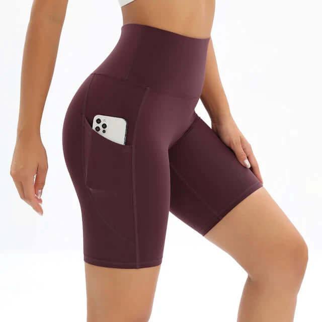 Women's polished high-waisted bike shorts with side pockets for activewear & workouts.