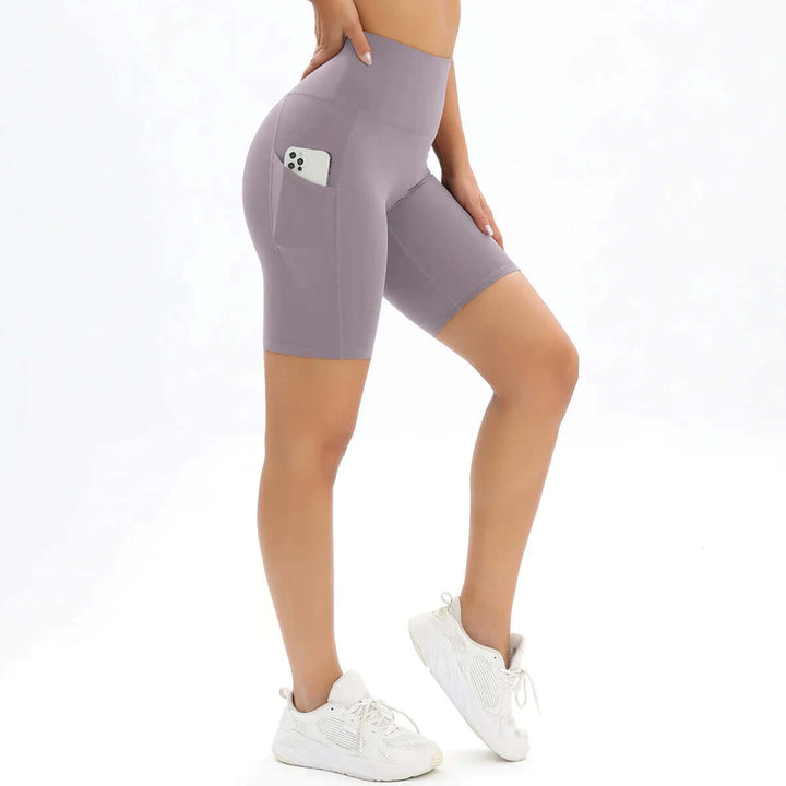 Supportive women's compression bike shorts, high-waisted & pocketed for gym & athletic activities.
