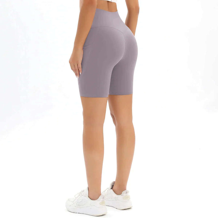 Chic women's high-waisted pocket bike shorts, excellent for activewear, yoga & everyday comfort.