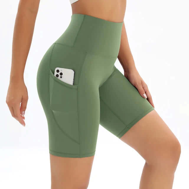 Sleek polished women's high-waisted bike shorts featuring practical side pockets for sportswear.