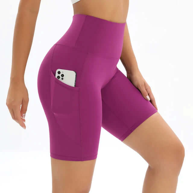 Durable women's workout bike shorts, high-waisted with pockets, ideal for active performance.