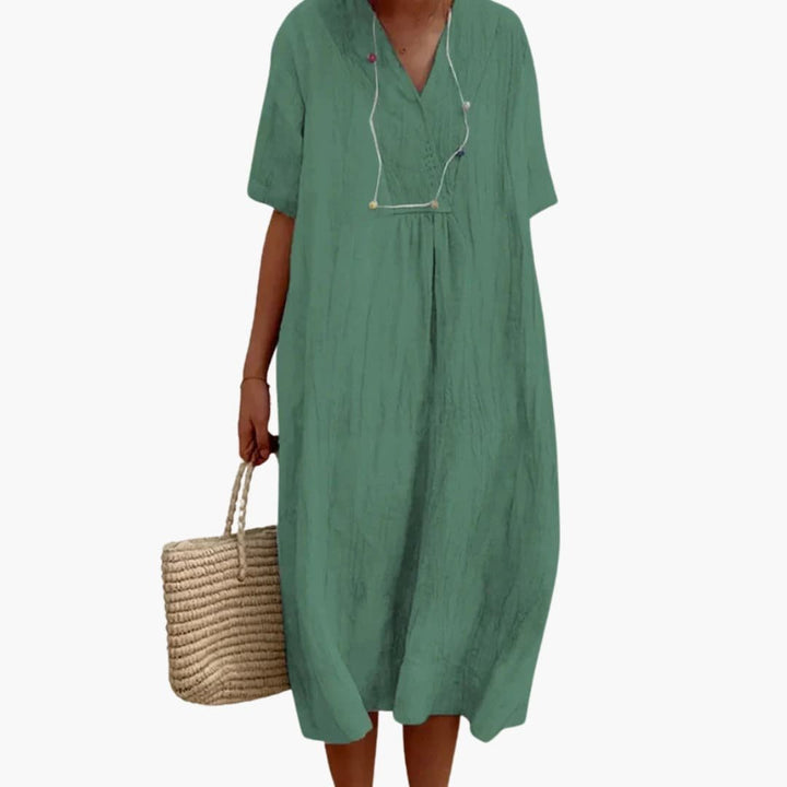 Elegant linen V-neck midi dress for women, perfect as a relaxed fit summer, beach, or travel dress.