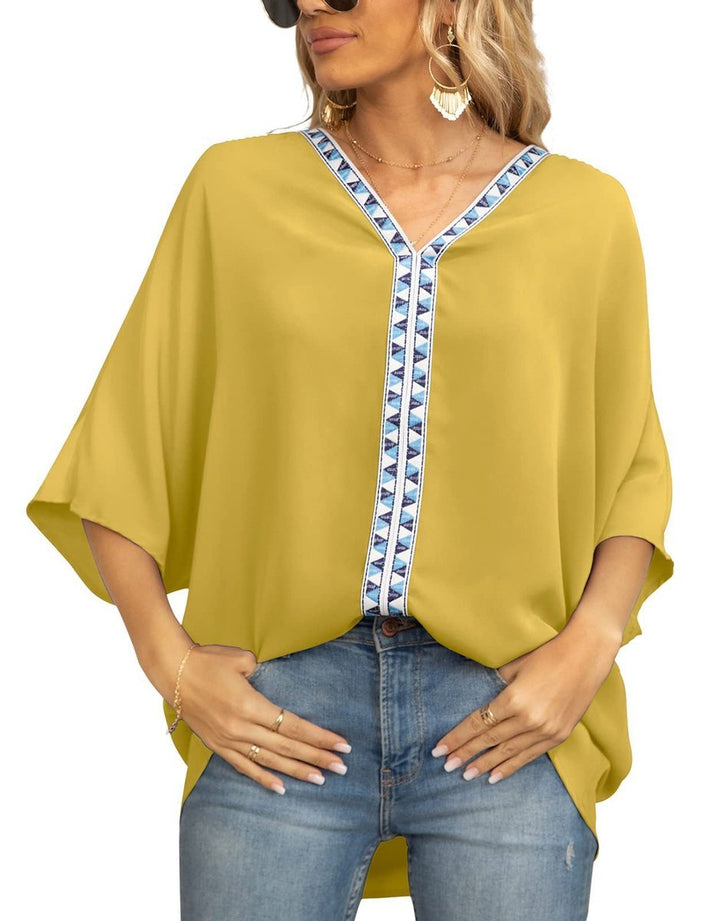 Elegant women's boho tunic featuring embroidered details, an oversized fit, and a high-low hem.