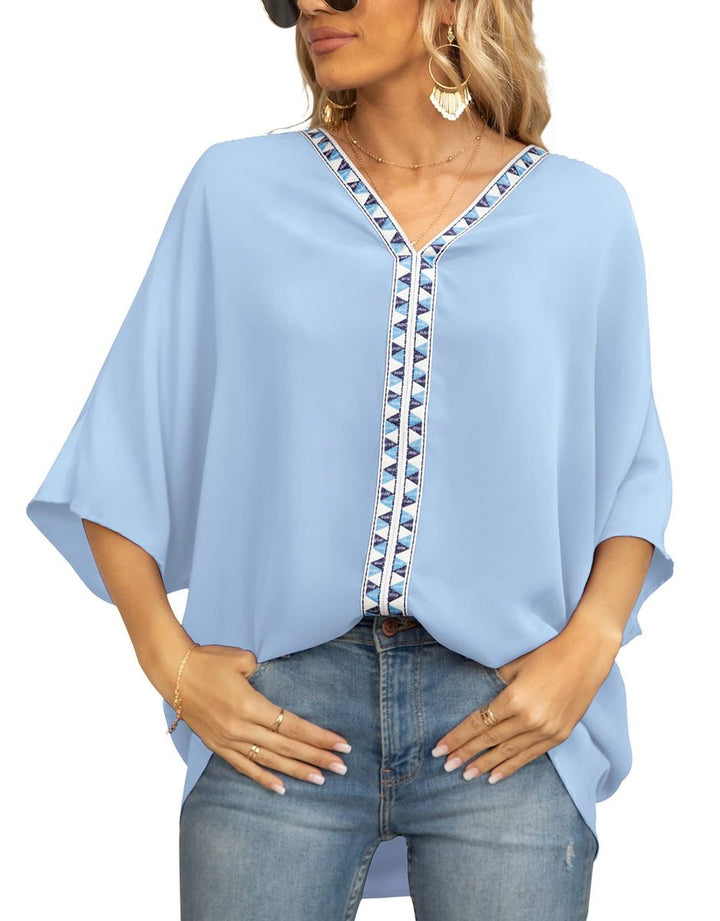 Oversized V-neck women's tunic, featuring delicate boho embroidery and a stylish high-low hem.