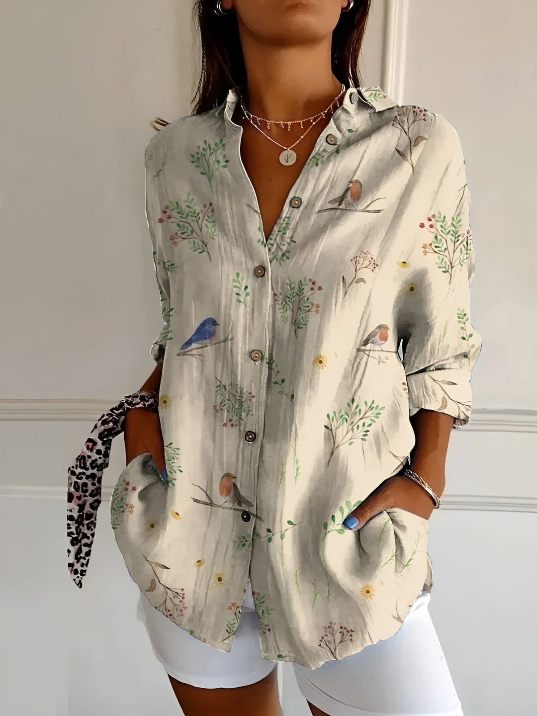 Elegant women's patterned button-up blouse with V-neck & long sleeves. Stylish & professional workwear.