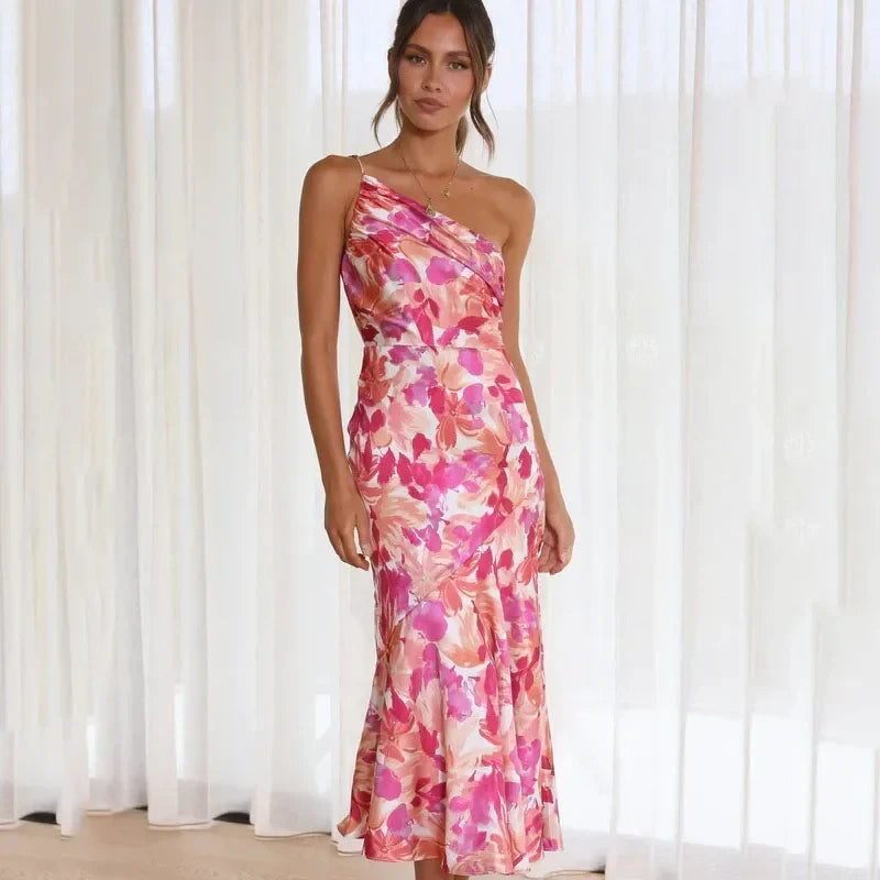 Women's elegant pink floral asymmetrical midi dress with one shoulder design, perfect for summer parties.