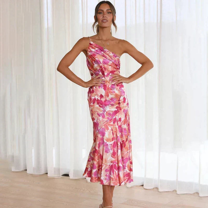 Full view of women's chic pink floral asymmetrical midi dress, featuring a flattering one-shoulder cut.