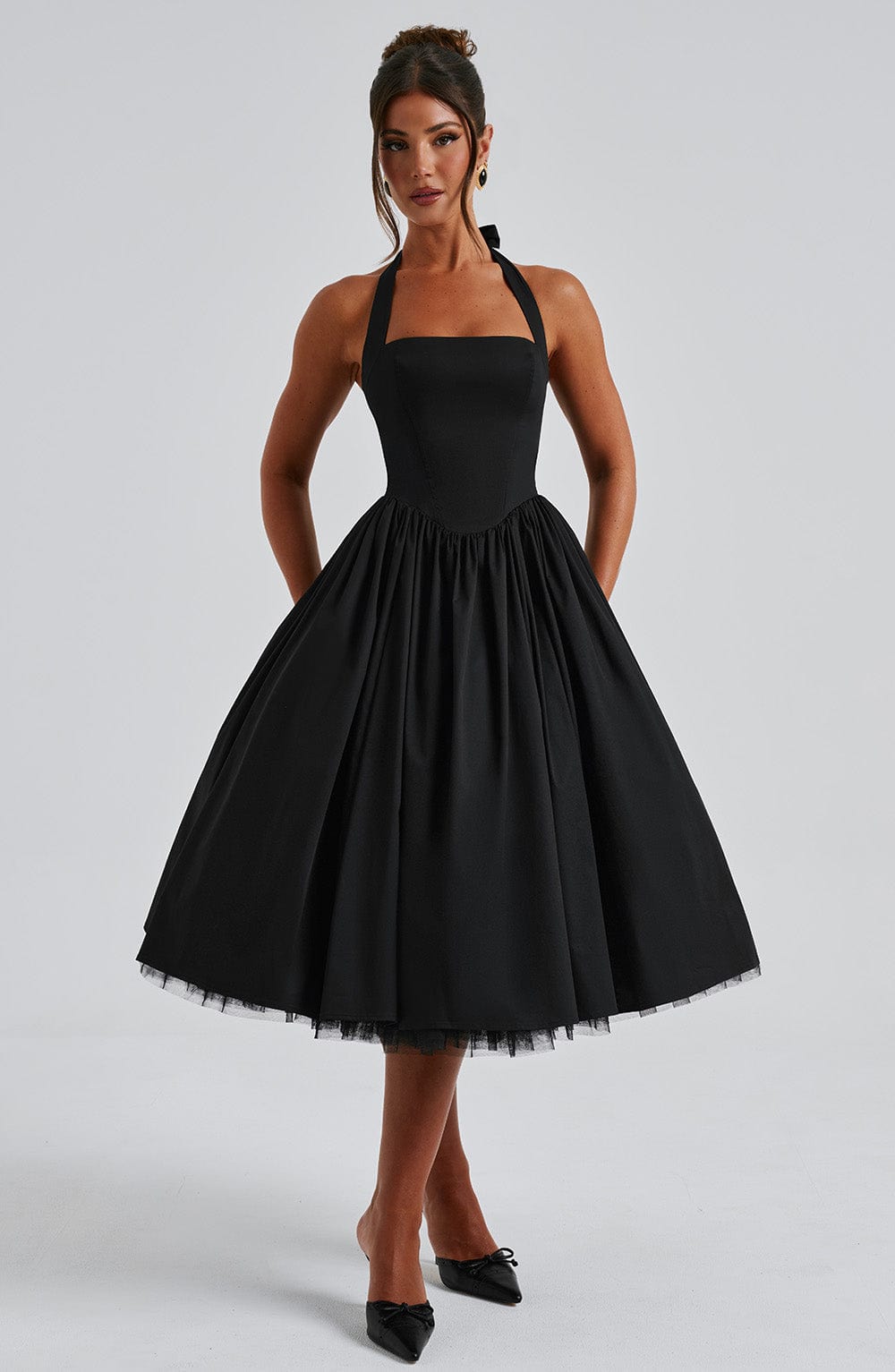 Classic black halter midi dress with a feminine flared skirt design.